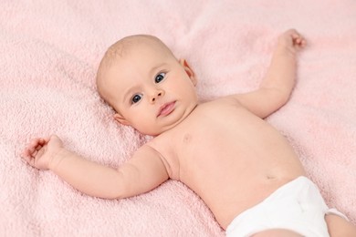 Photo of Cute little baby with cream on face on pink blanket, above view