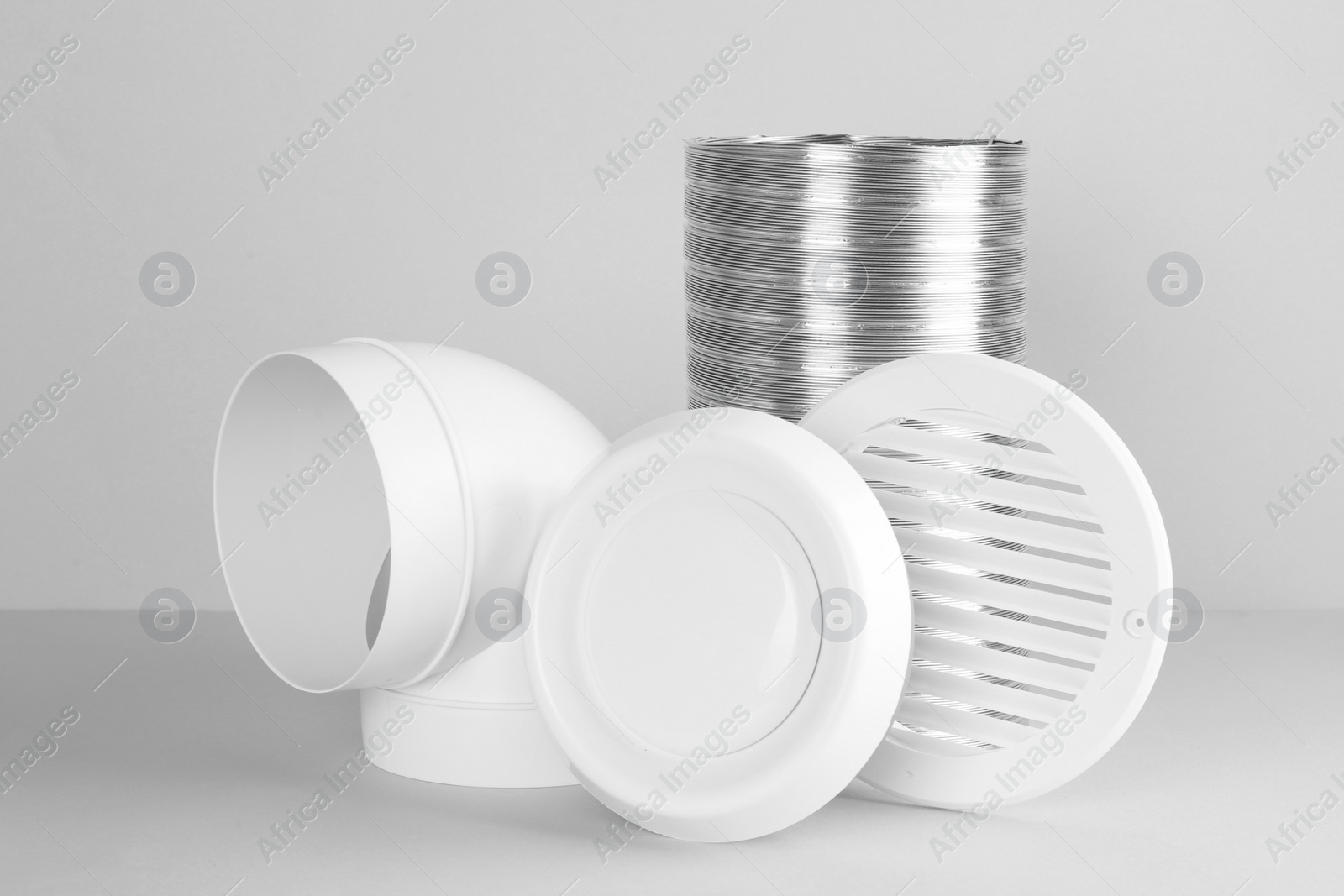 Photo of Parts of home ventilation system on light grey background