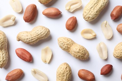 Fresh peanuts on white background, flat lay