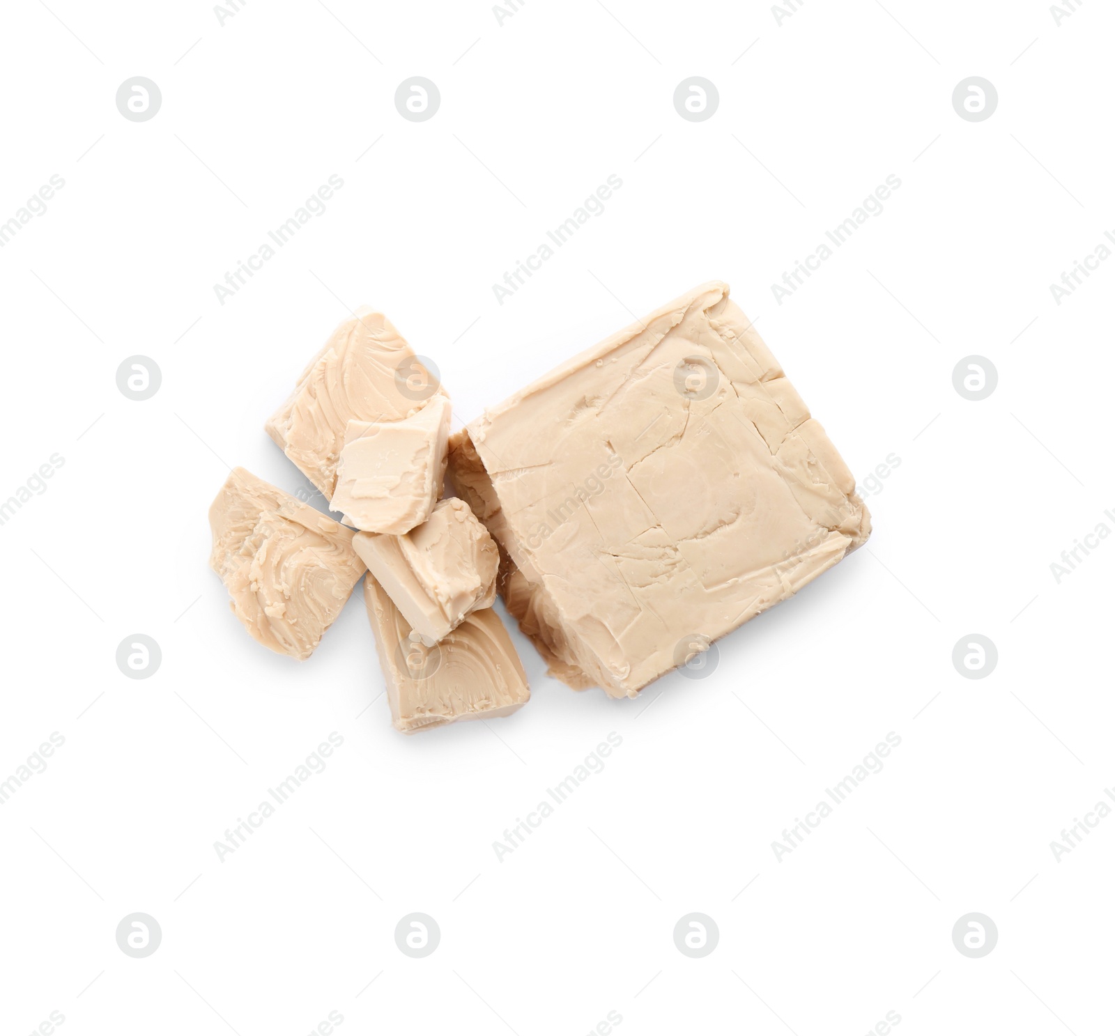 Photo of Pieces of compressed yeast on white background, top view