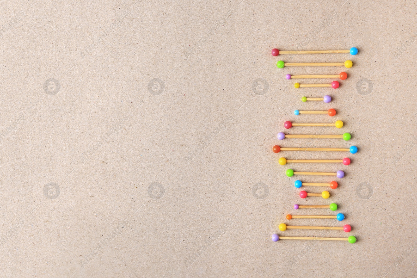 Photo of Model of DNA molecular chain on beige background, top view. Space for text