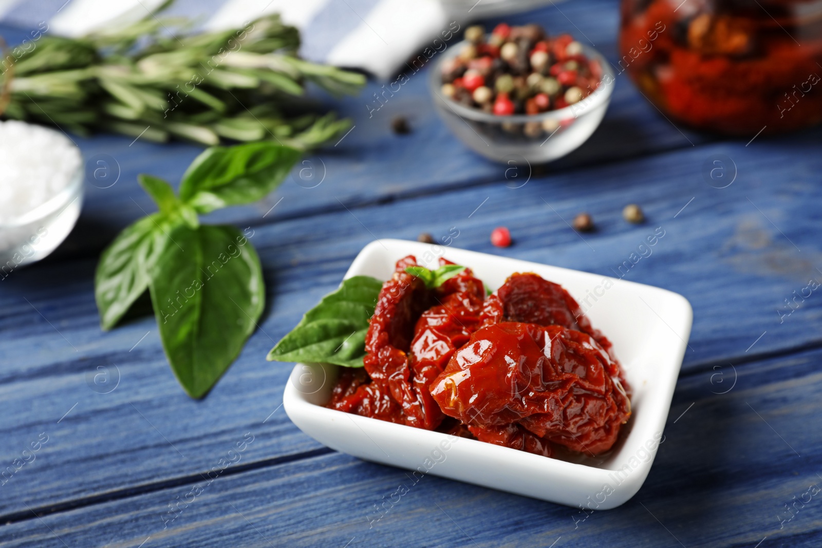 Photo of Dried tomatoes in bowl on table. Healthy snack