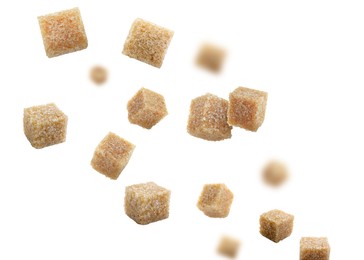 Image of Brown cane sugar cubes falling on white background