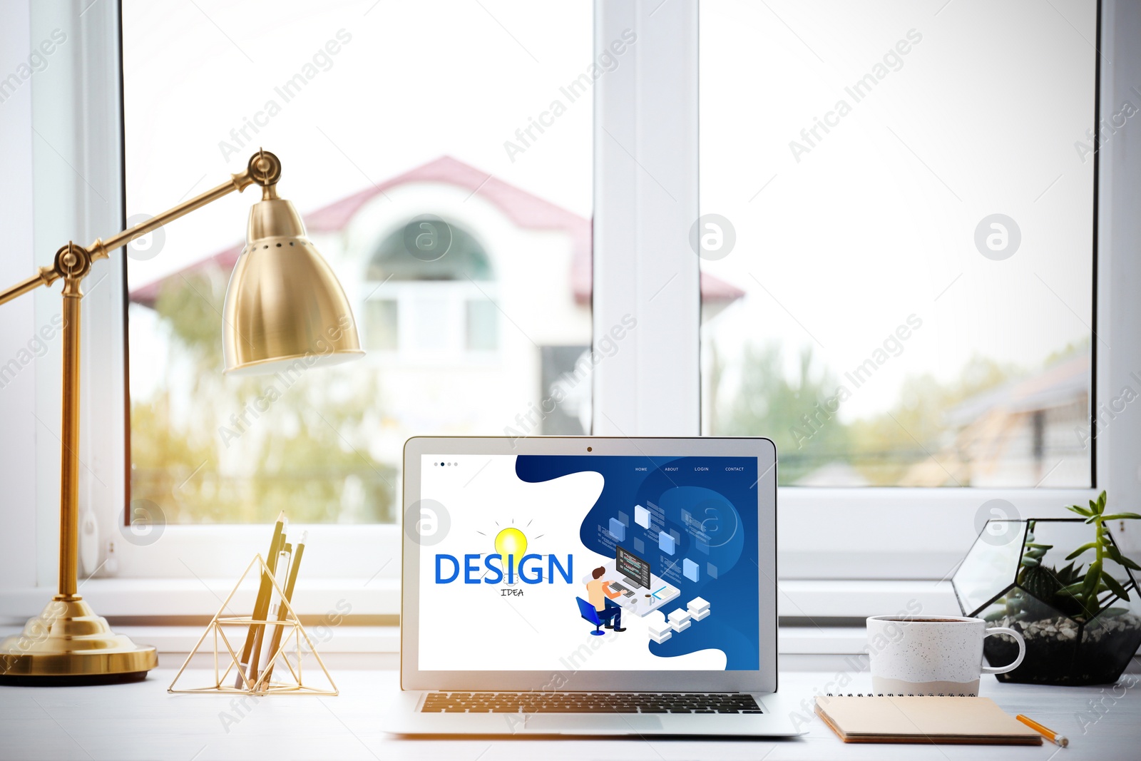 Image of Modern designer's workplace with laptop in office