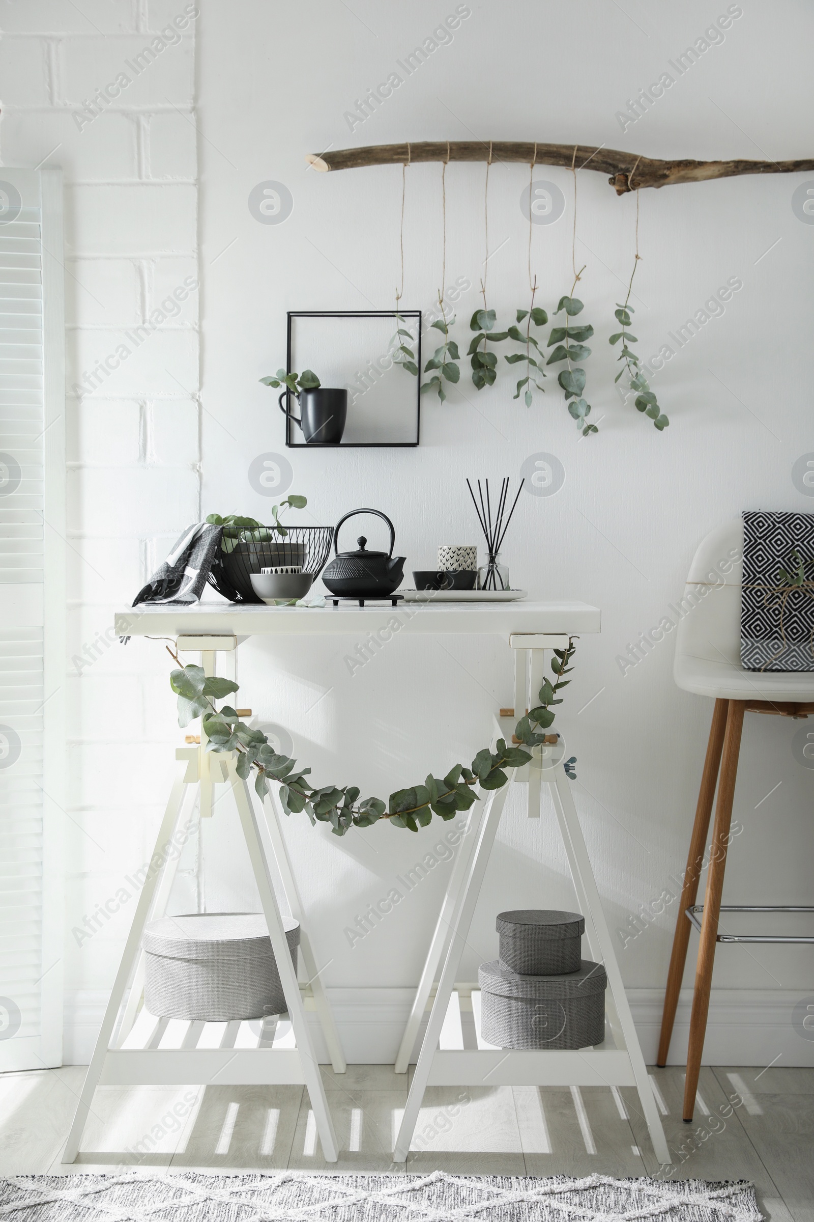 Photo of Stylish room decorated with beautiful green eucalyptus branches