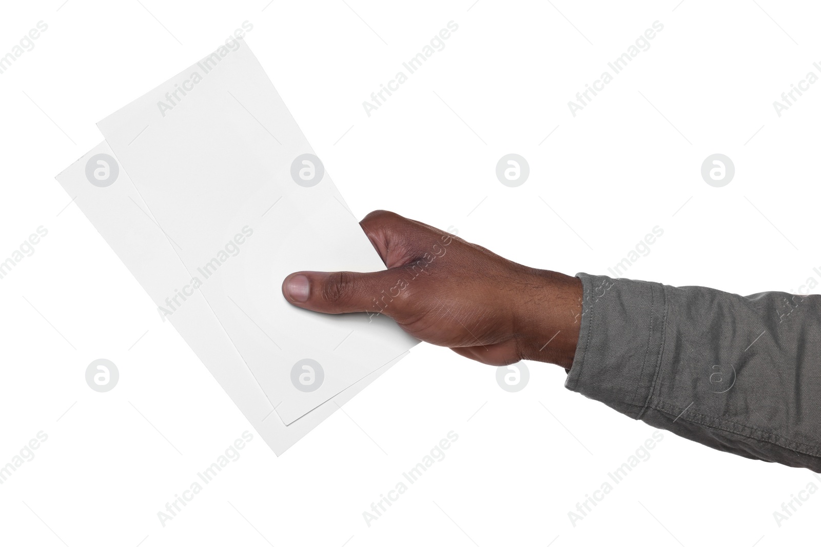 Photo of African American man holding flyers on white background, closeup. Mockup for design