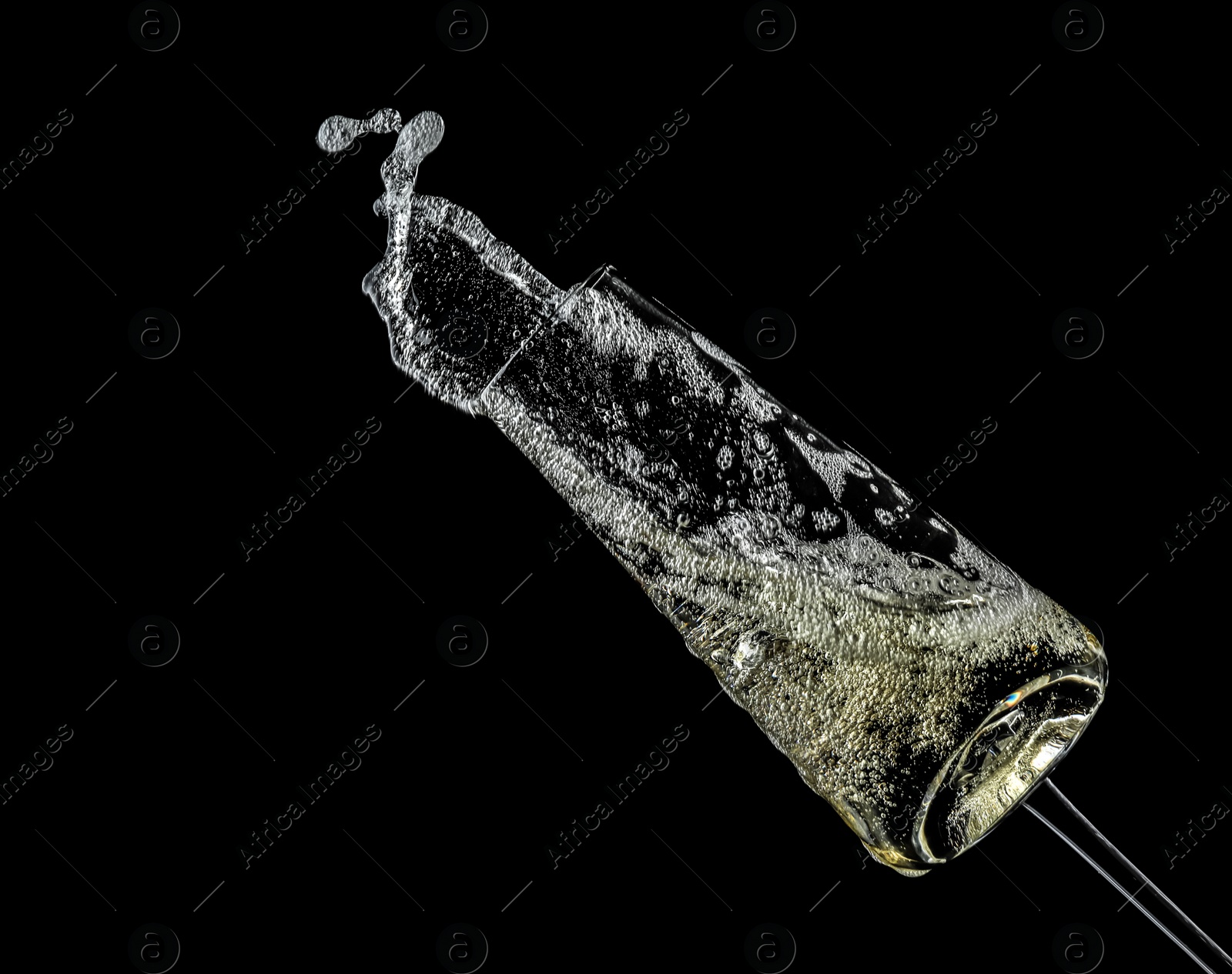 Photo of Glass of champagne on black background. Festive drink