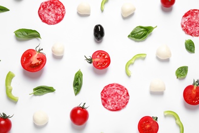 Flat lay composition with fresh ingredients for pizza on white background