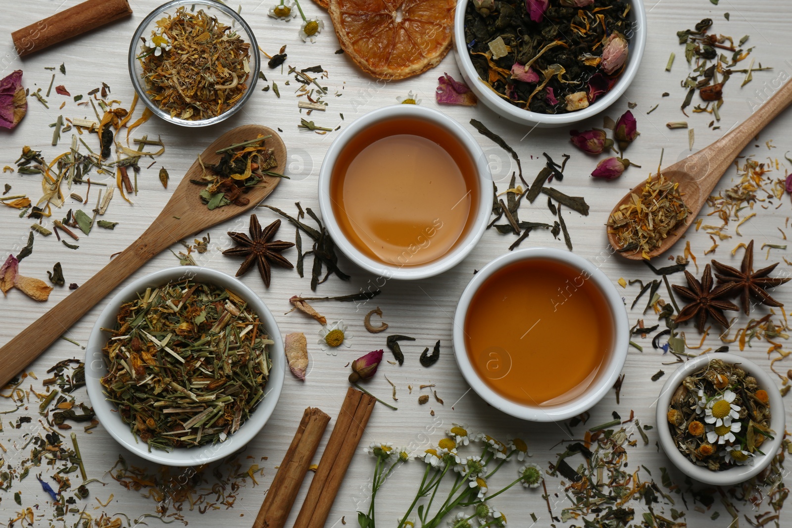 Photo of Flat lay composition with fresh brewed tea and dry leaves on wooden table