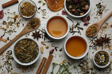 Flat lay composition with fresh brewed tea and dry leaves on wooden table