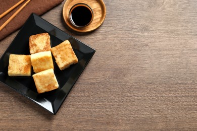 Photo of Delicious turnip cake served on wooden table, flat lay. Space for text