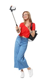 Photo of Attractive young woman taking selfie on white background