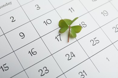 Photo of 17th March marked with fresh clover on calendar. St. Patrick's Day celebration