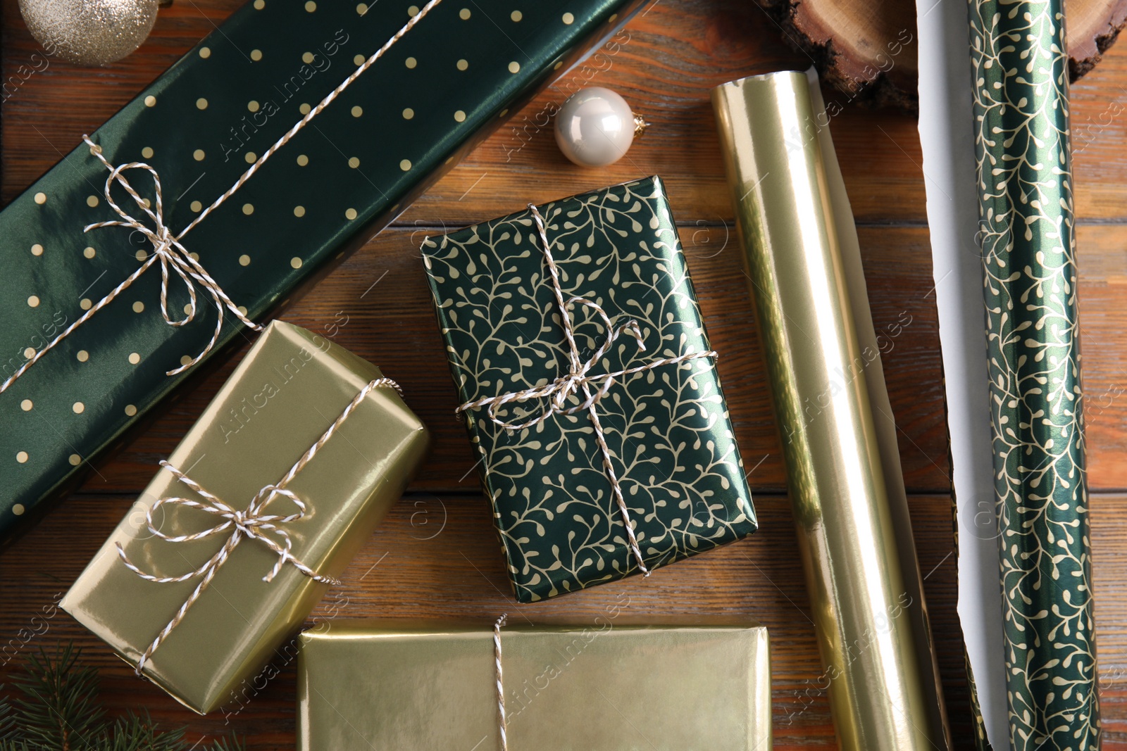 Photo of Flat lay composition with beautifully wrapped gift boxes on wooden table