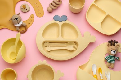 Photo of Flat lay composition with baby feeding accessories and bibs on pink background