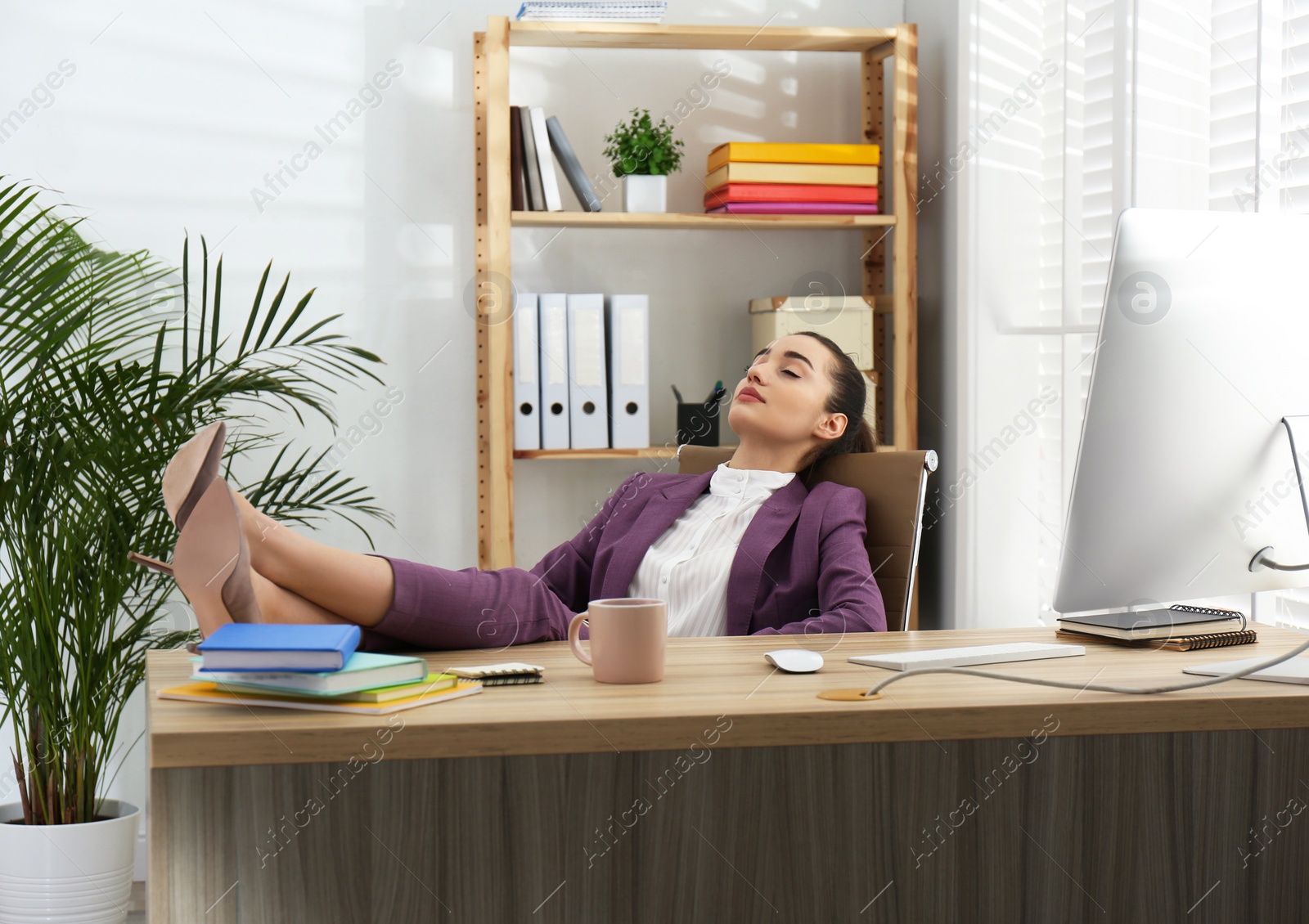 Photo of Lazy employee sleeping at table in office