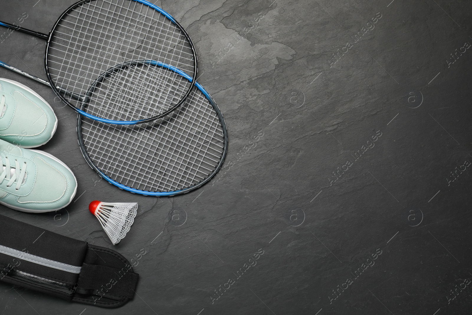 Photo of Different sports equipment on black table, flat lay. Space for text