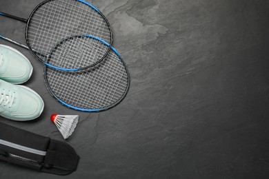 Different sports equipment on black table, flat lay. Space for text