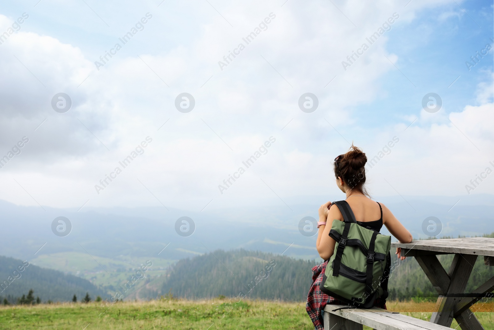 Photo of Woman with backpack in wilderness on cloudy day