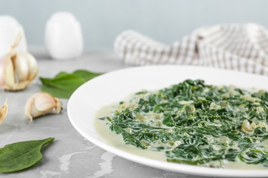 Photo of Tasty spinach dip on grey marble table, closeup