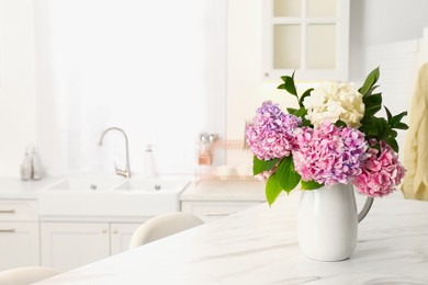 Photo of Bouquet with beautiful hydrangea flowers on white marble table. Space for text
