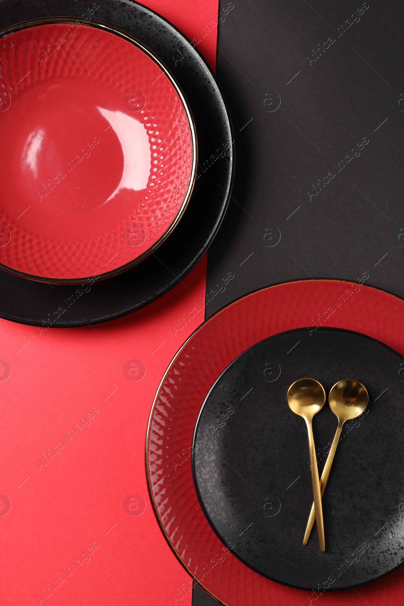 Photo of Stylish table setting with plates and spoons on color background, top view