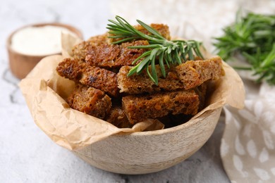 Photo of Crispy rusks with rosemary on white table
