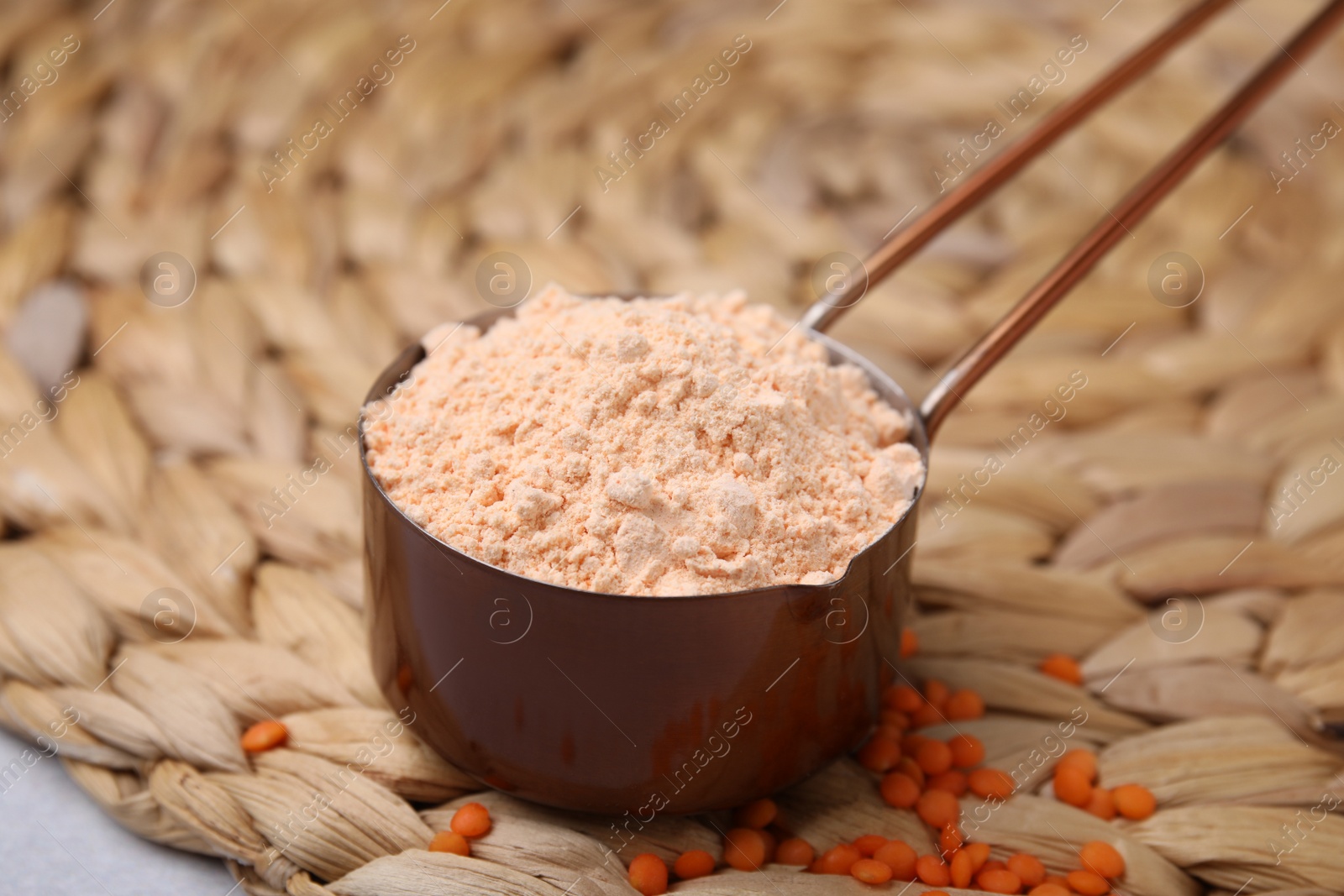 Photo of Organic lentil flour on wicker mat, closeup