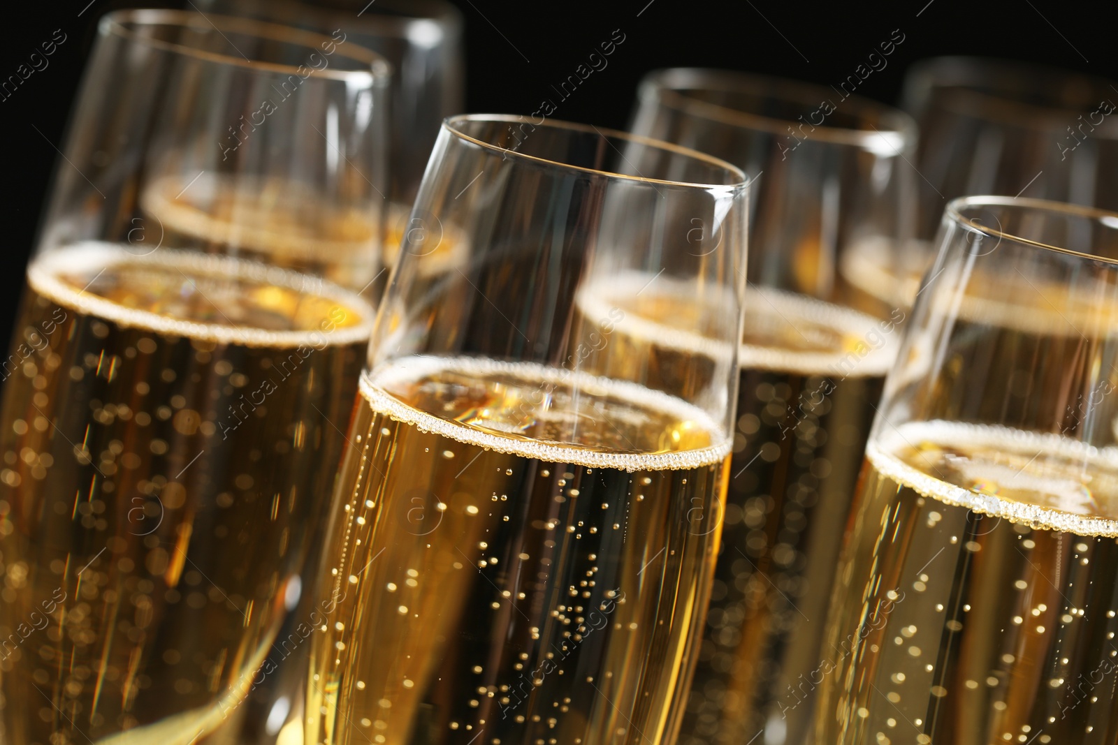 Photo of Glasses of champagne on dark background, closeup