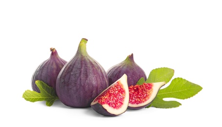 Whole and cut purple figs on white background