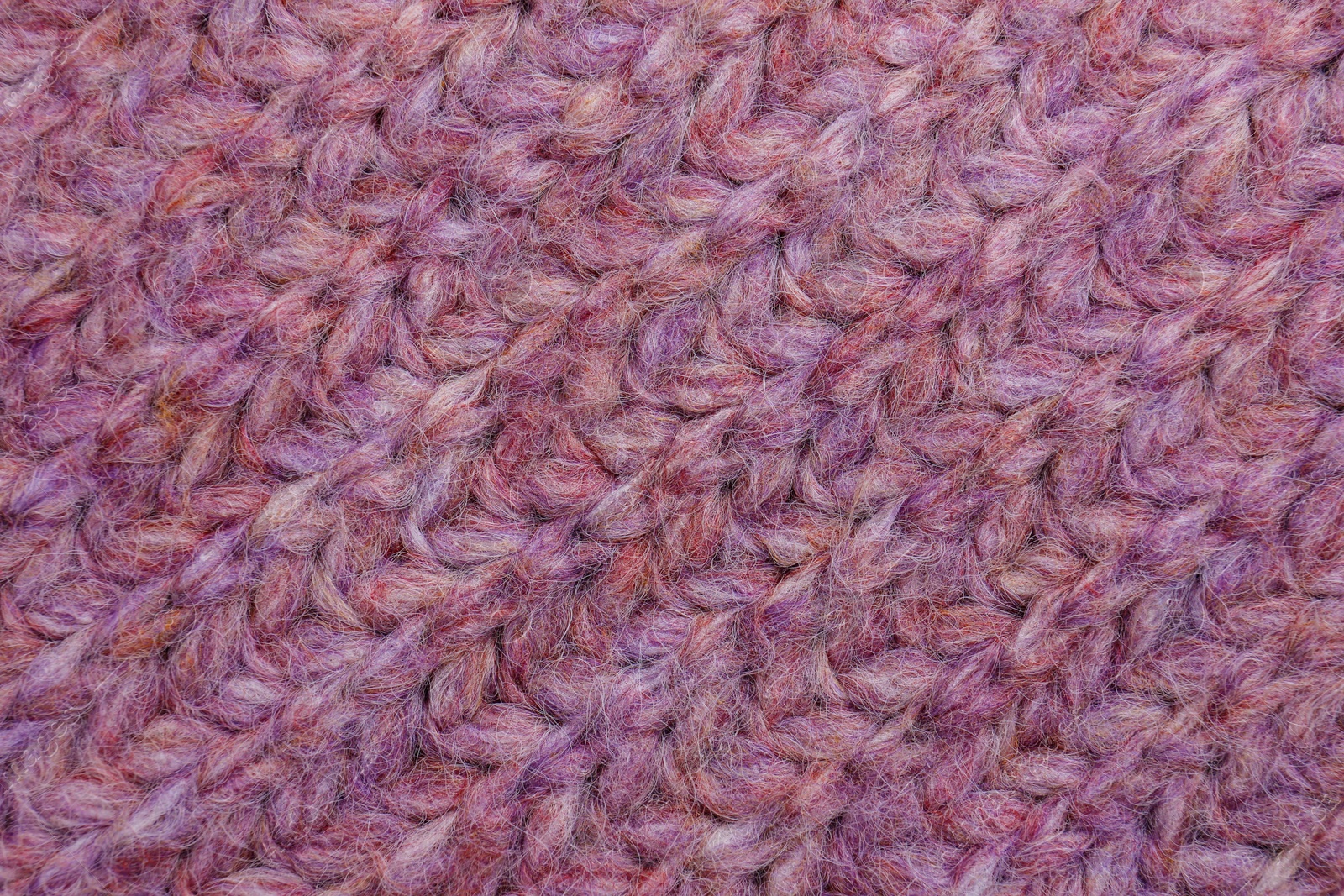 Photo of Violet knitted fabric as background, top view