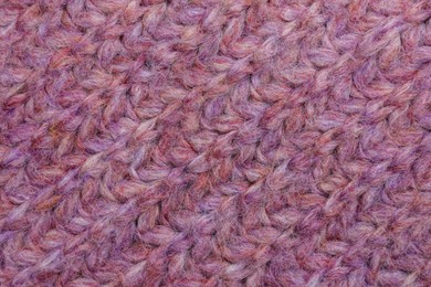 Photo of Violet knitted fabric as background, top view