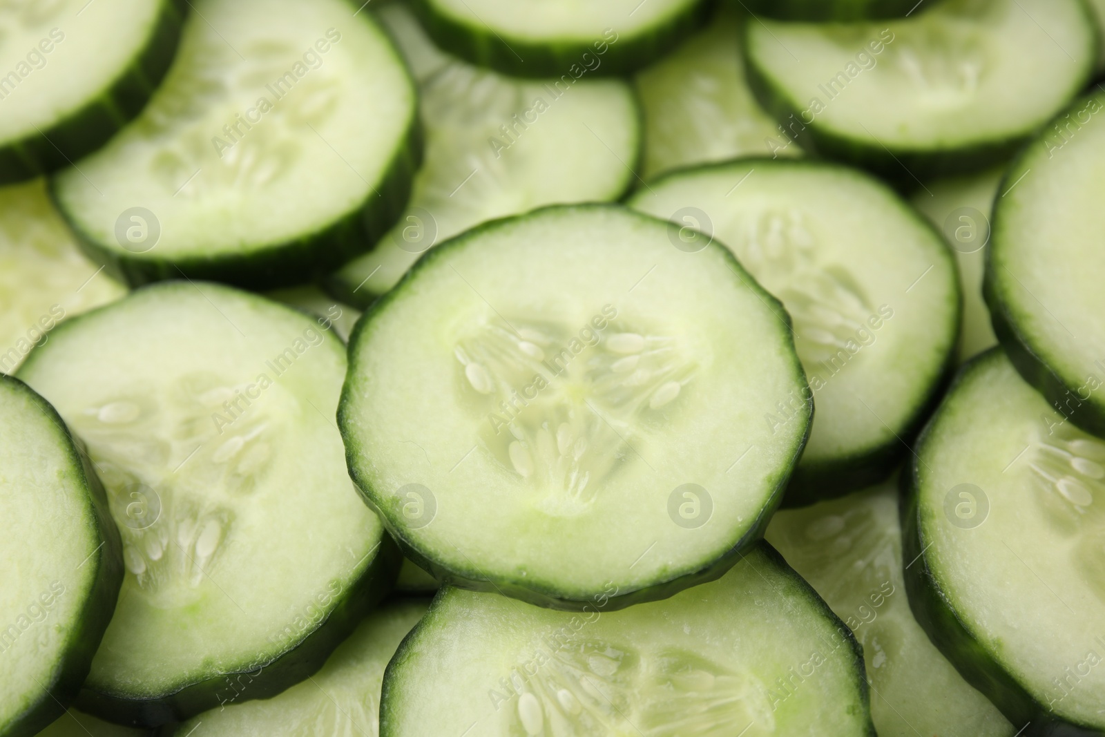 Photo of Fresh slices of cucumbers as background, closeup