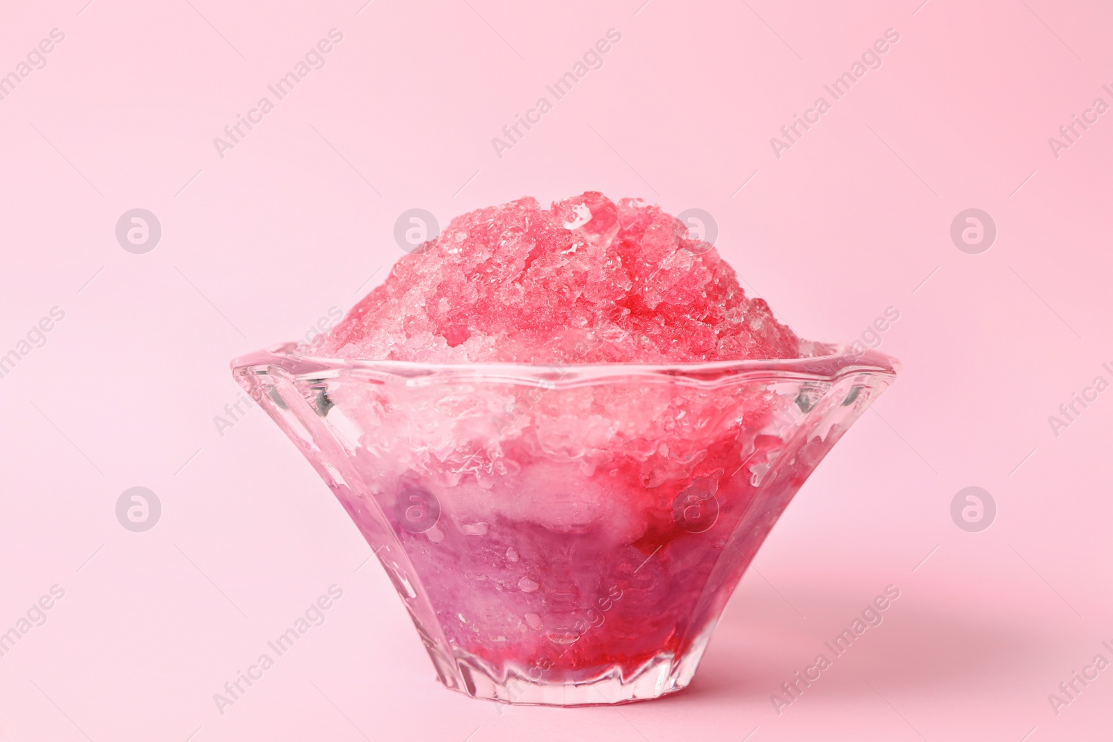 Photo of Shaving ice in glass dessert bowl on pink background, closeup