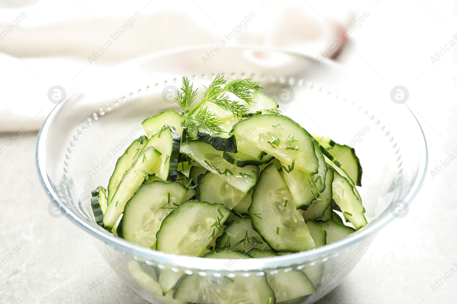 Photo of Delicious cucumber salad with dill in bowl on table, closeup