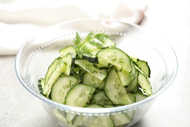 Photo of Delicious cucumber salad with dill in bowl on table, closeup