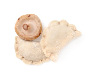 Raw dumplings (varenyky) and fresh mushrooms isolated on white, top view