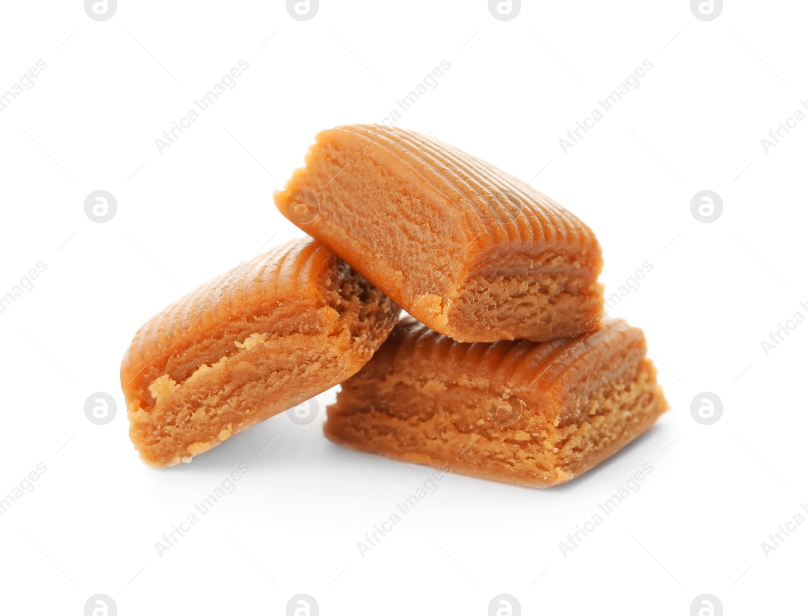 Photo of Delicious caramel candies on white background