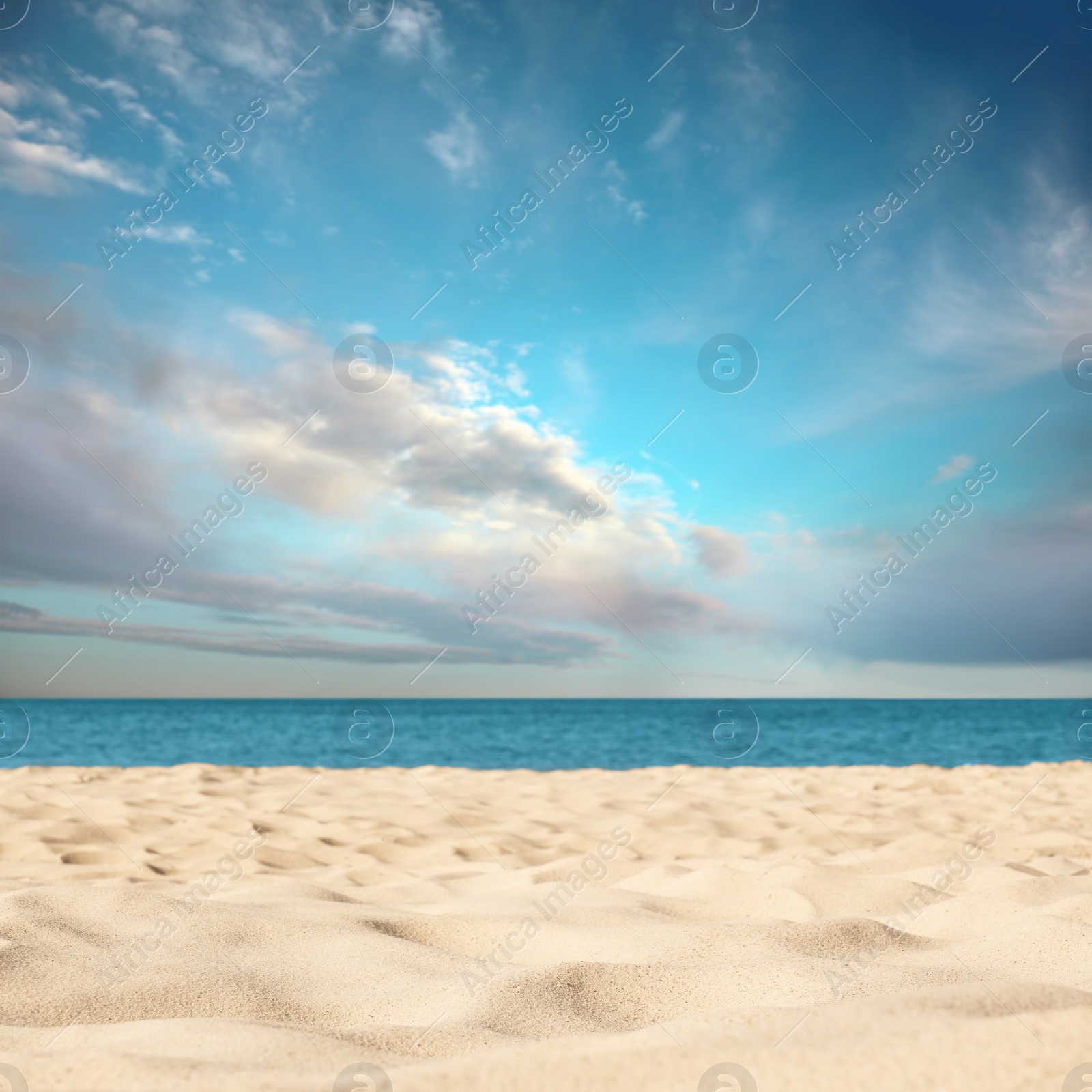 Image of Sandy beach near sea under blue sky with clouds