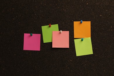 Colorful paper notes pinned to cork board