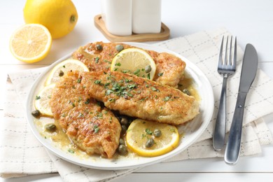 Photo of Delicious chicken piccata served on white table