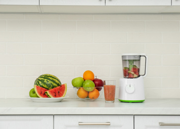 Photo of Blender and smoothie ingredients on counter in kitchen