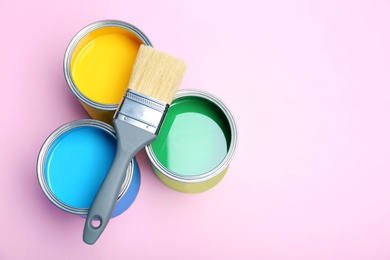 Photo of Flat lay composition with paint cans and brush on color background. Space for text