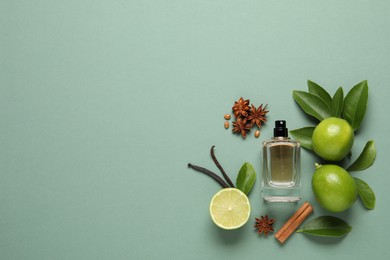 Photo of Flat lay composition with bottle of perfume and fresh citrus fruits on pale green background. space for text