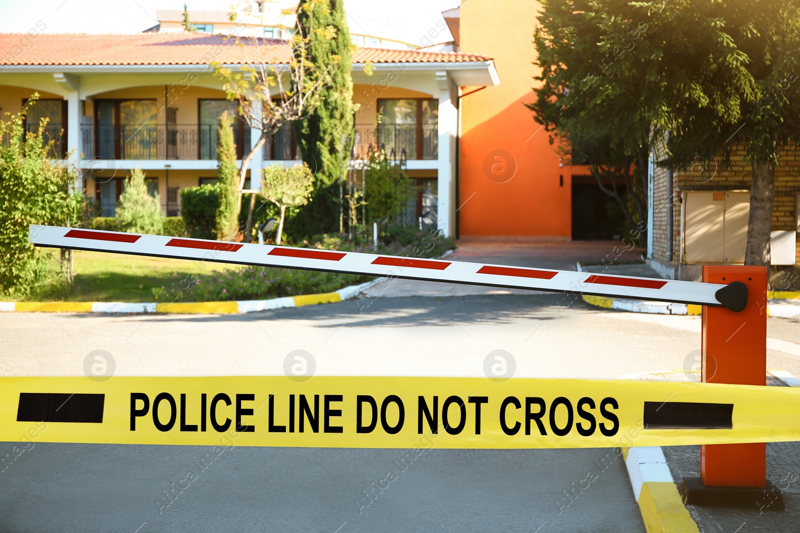 Image of Yellow crime scene tape blocking way on street