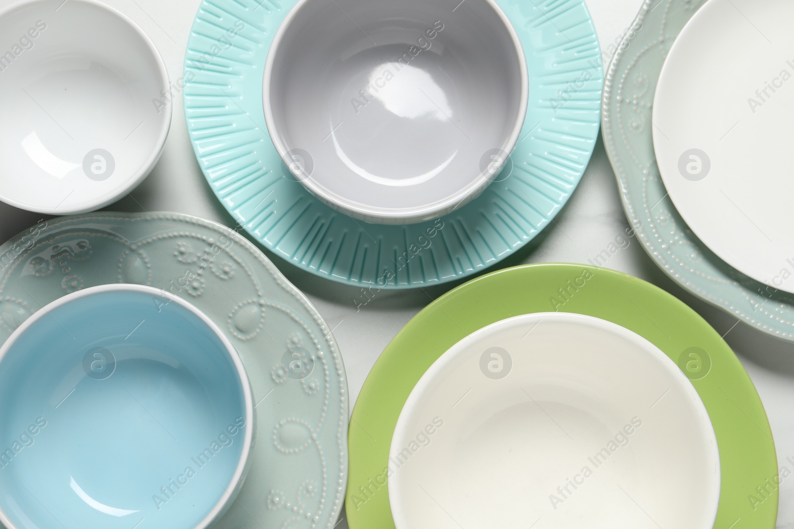 Photo of Beautiful ceramic dishware on white table, flat lay