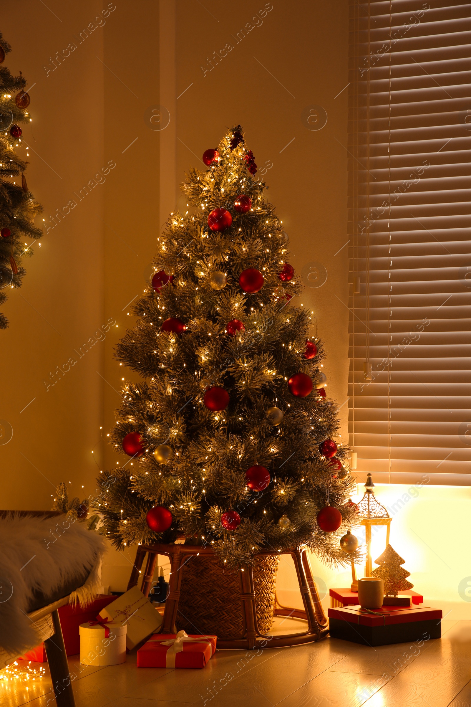 Photo of Beautiful decorated Christmas tree in festive room interior