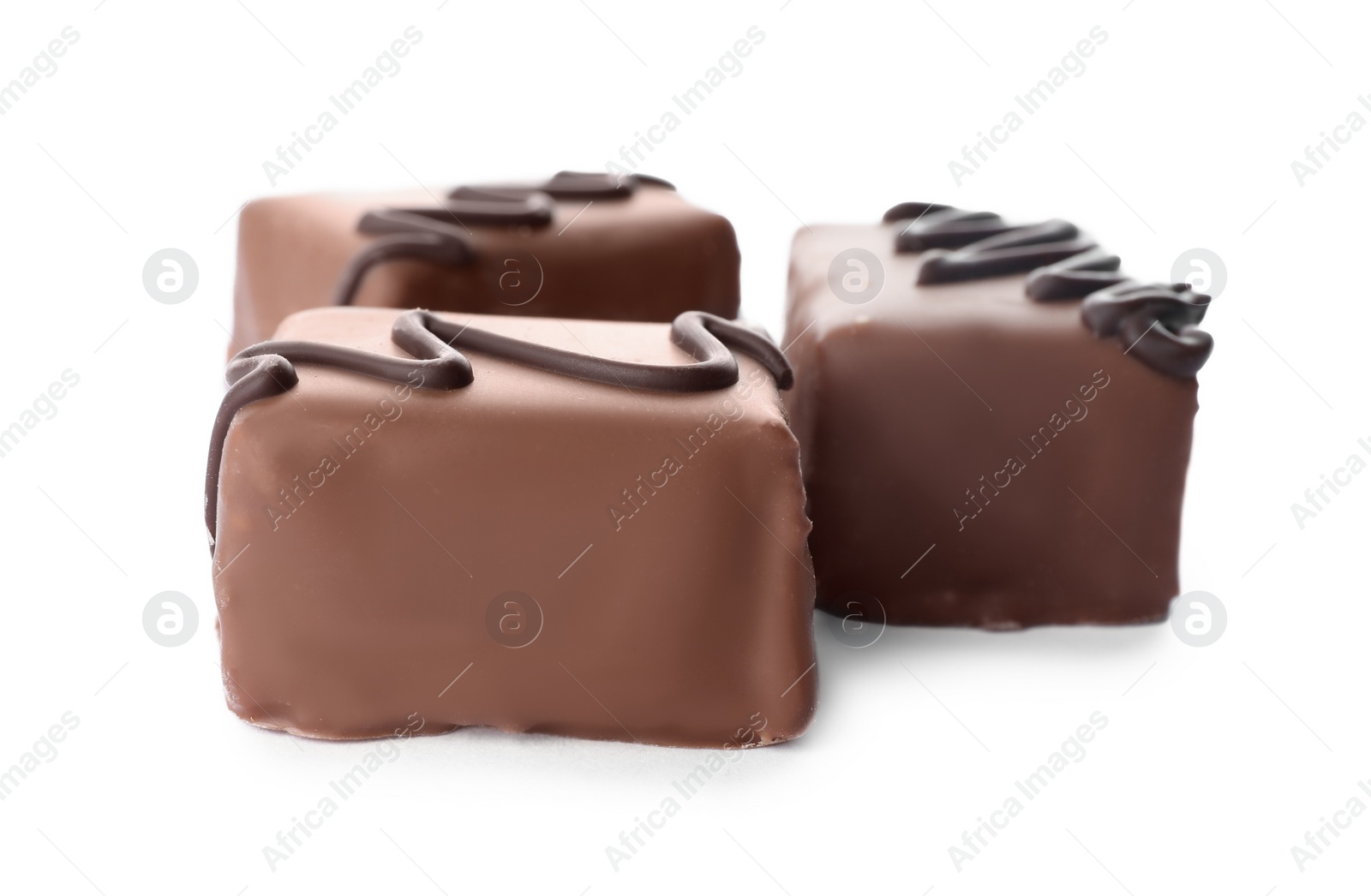 Photo of Delicious milk chocolate candies isolated on white