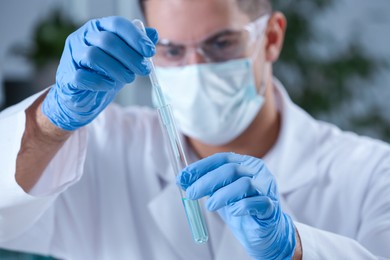 Photo of Scientist working with sample in chemical laboratory, focus on hands