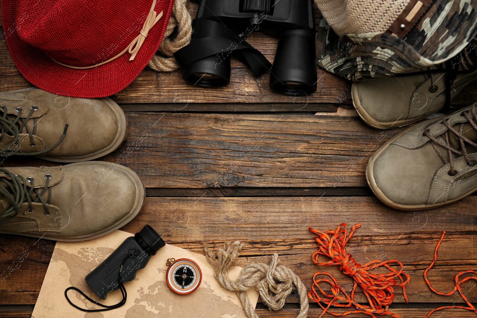 Photo of Flat lay composition with camping equipment on wooden background